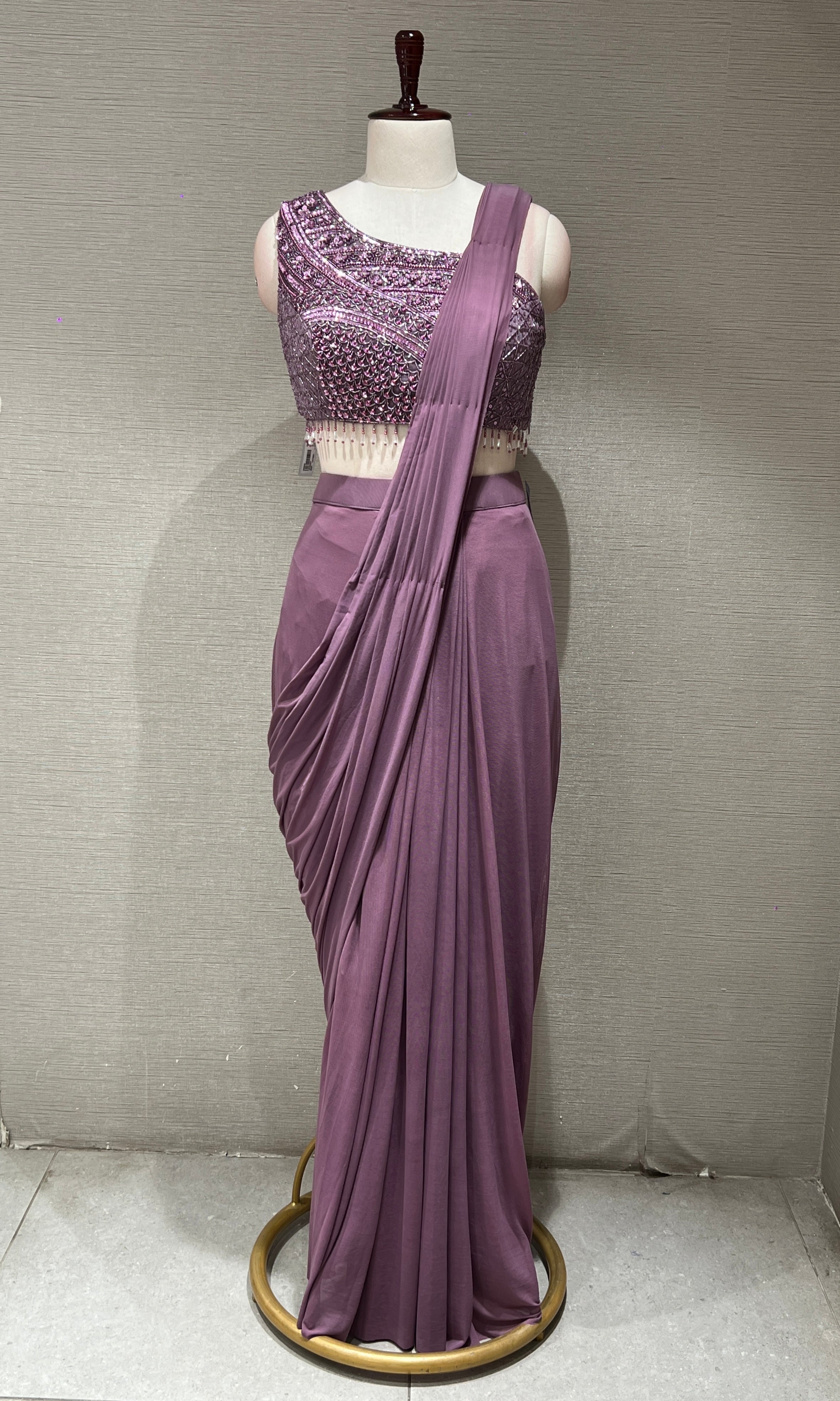 purple drape saree with asymmetrical blouse