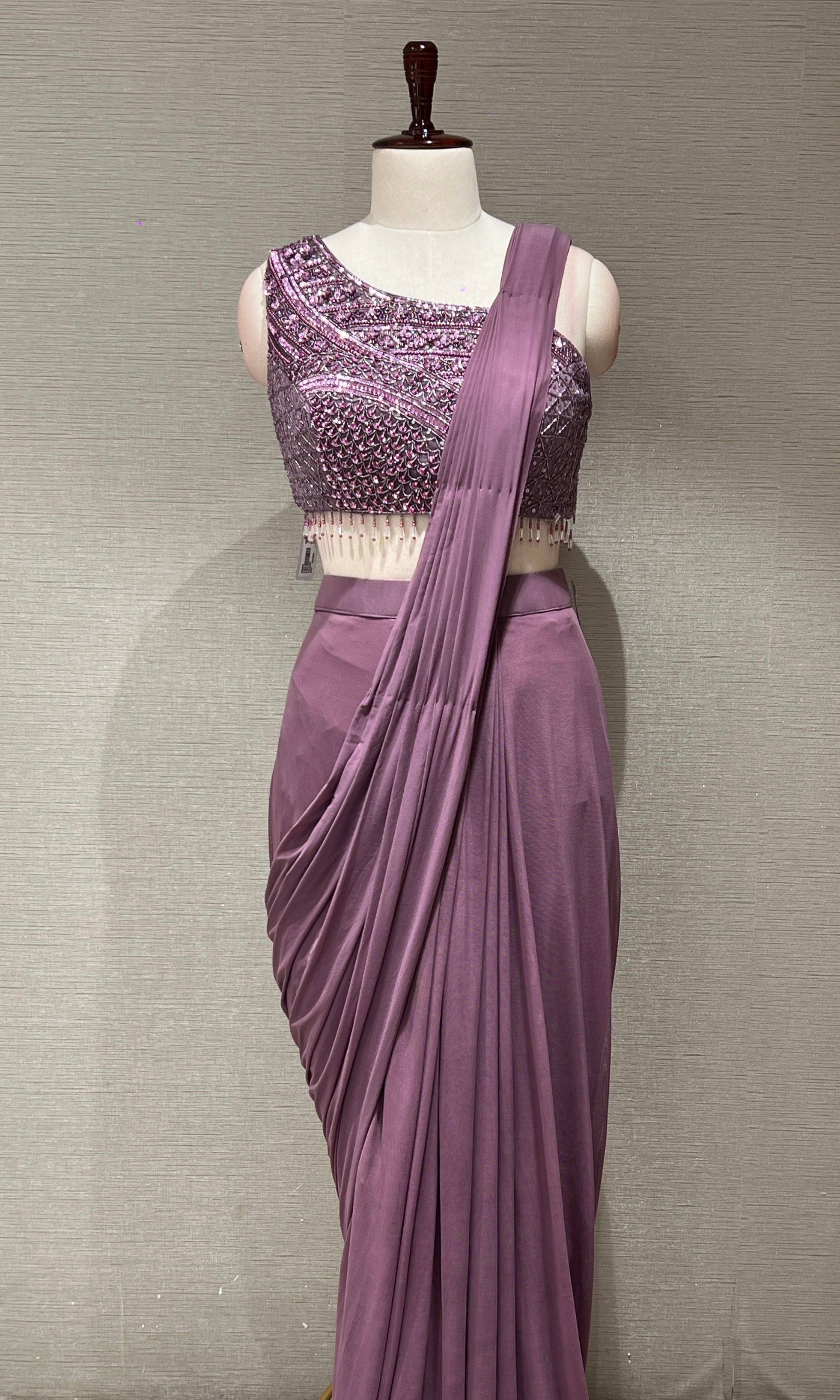 purple drape saree with asymmetrical blouse