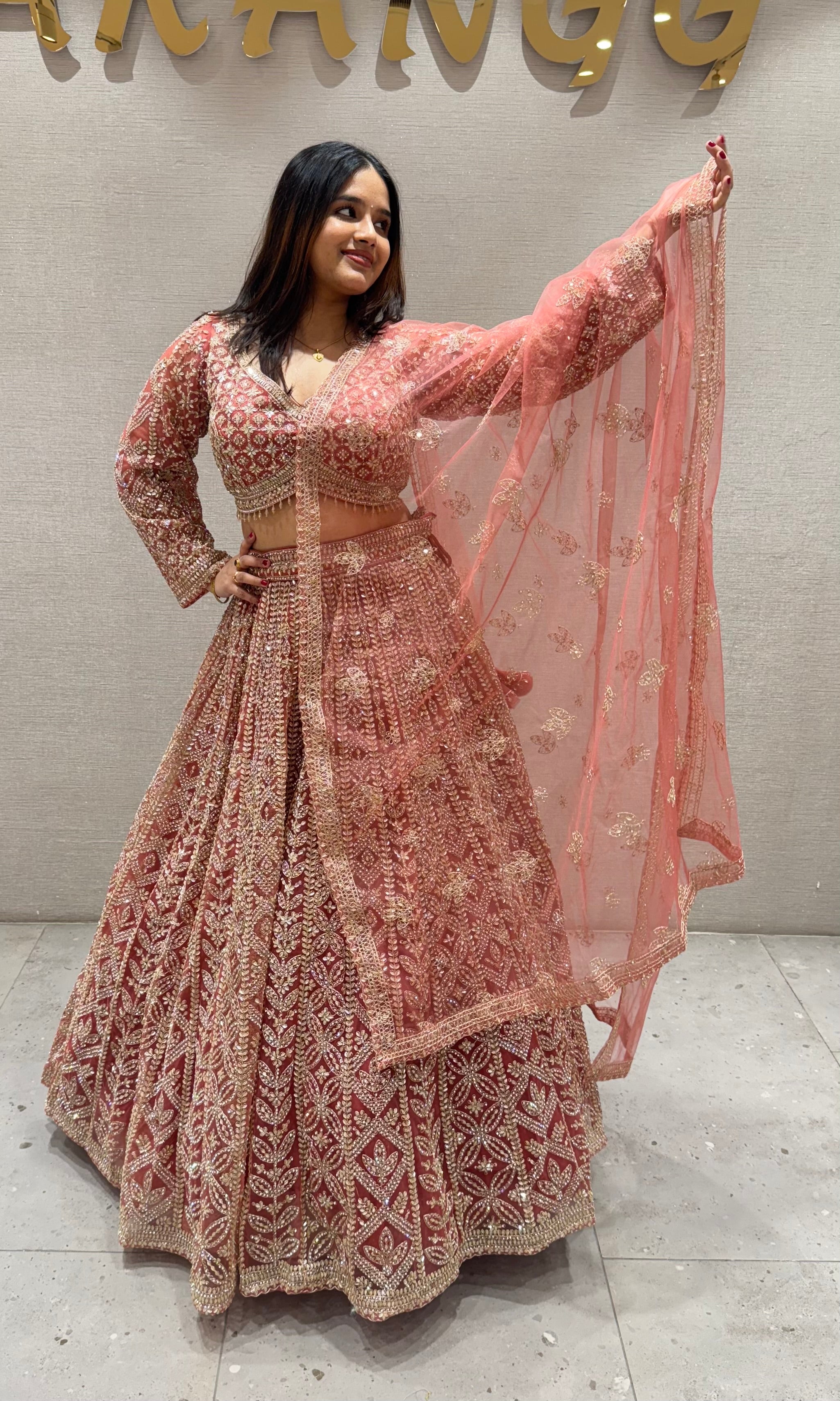 Peachy Orange lehenga with stone work