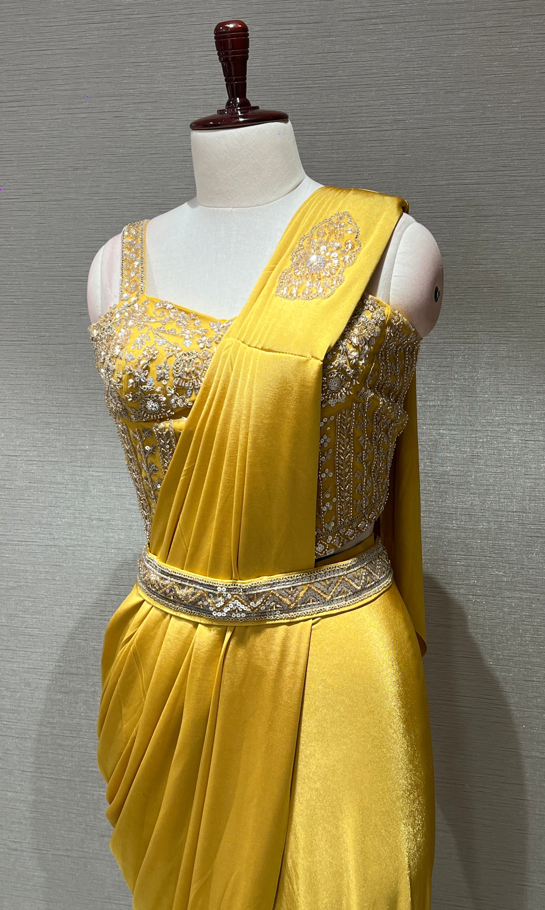 yellow drape saree with corset blouse and belt