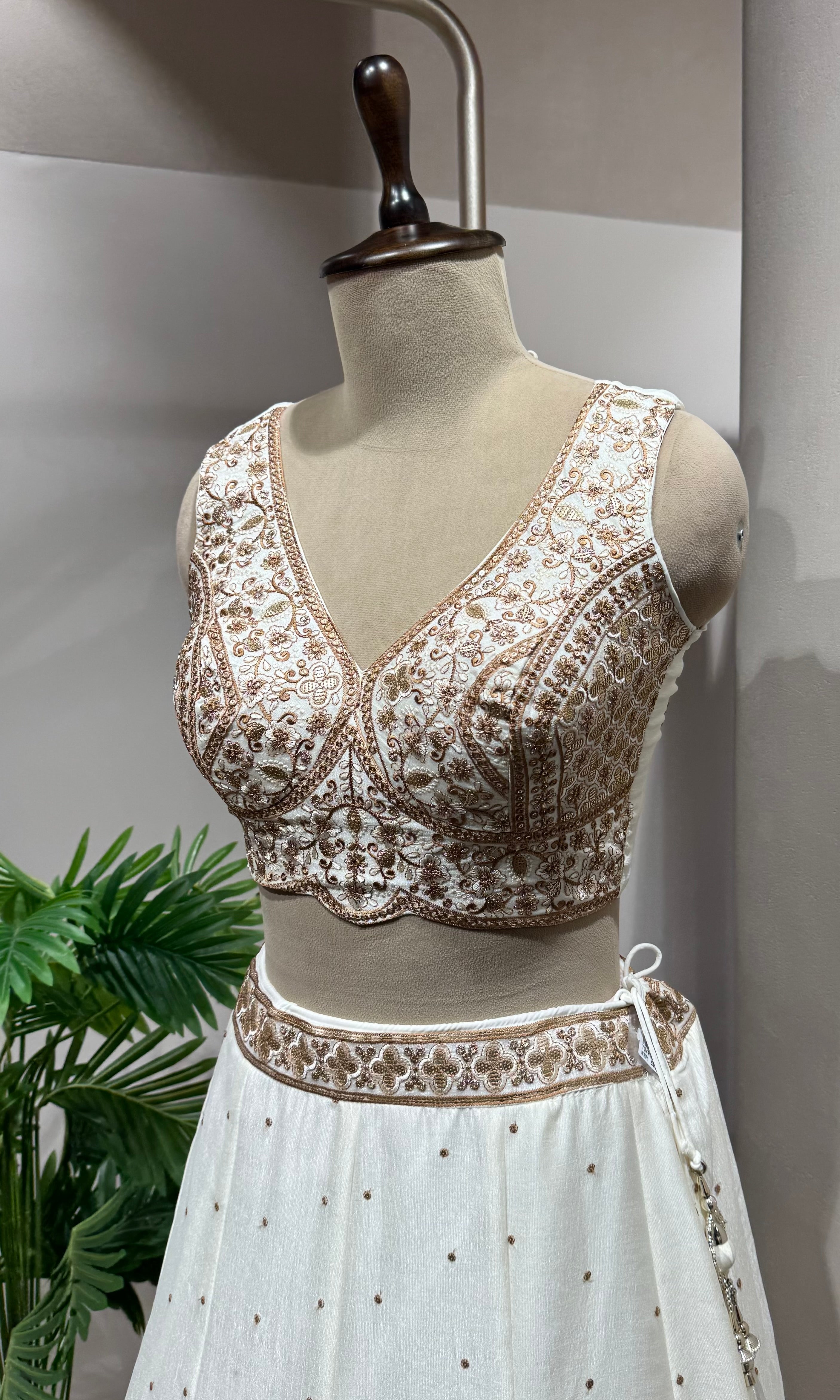 White Lehenga with gold embellished blouse