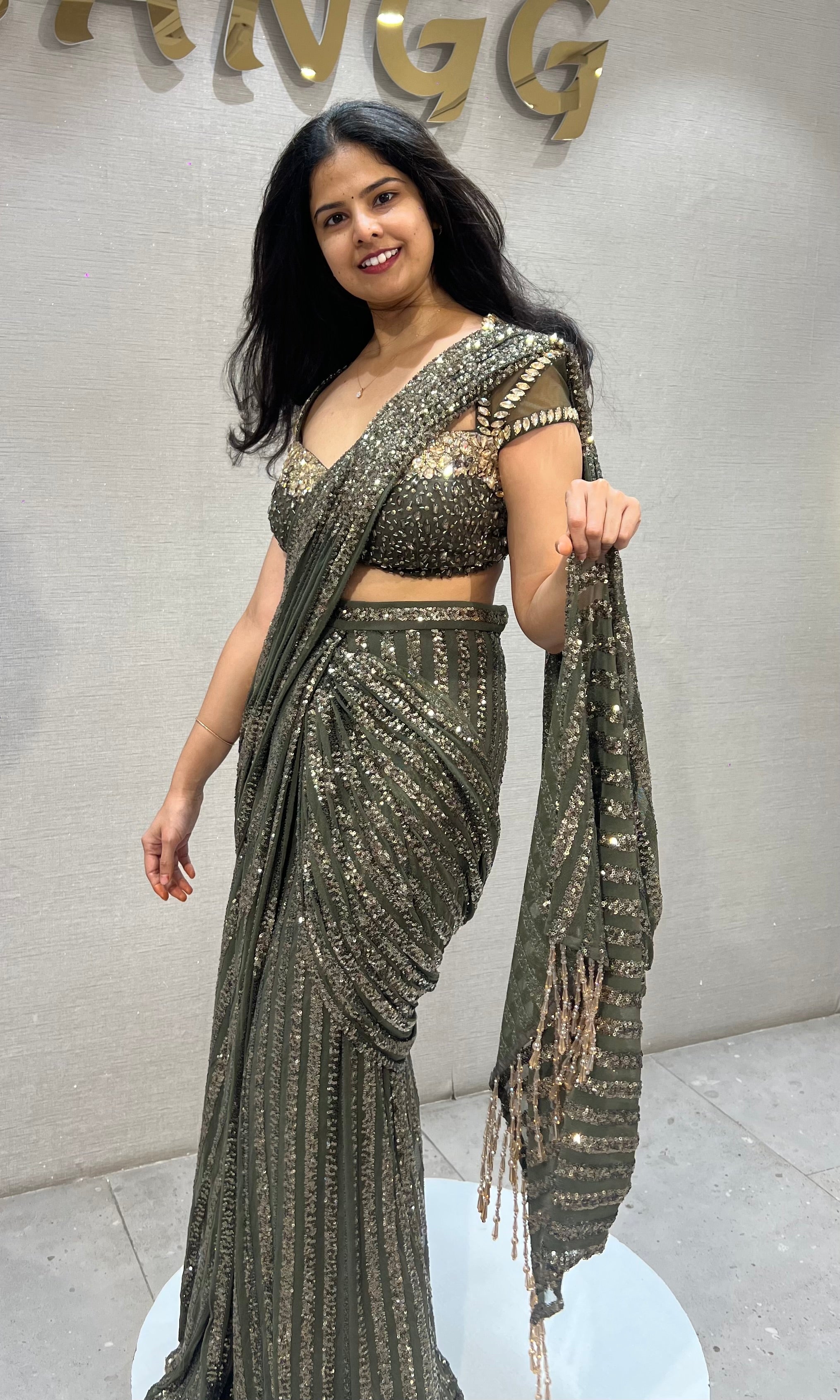 green shimmer metallic drape saree with embellished blouse