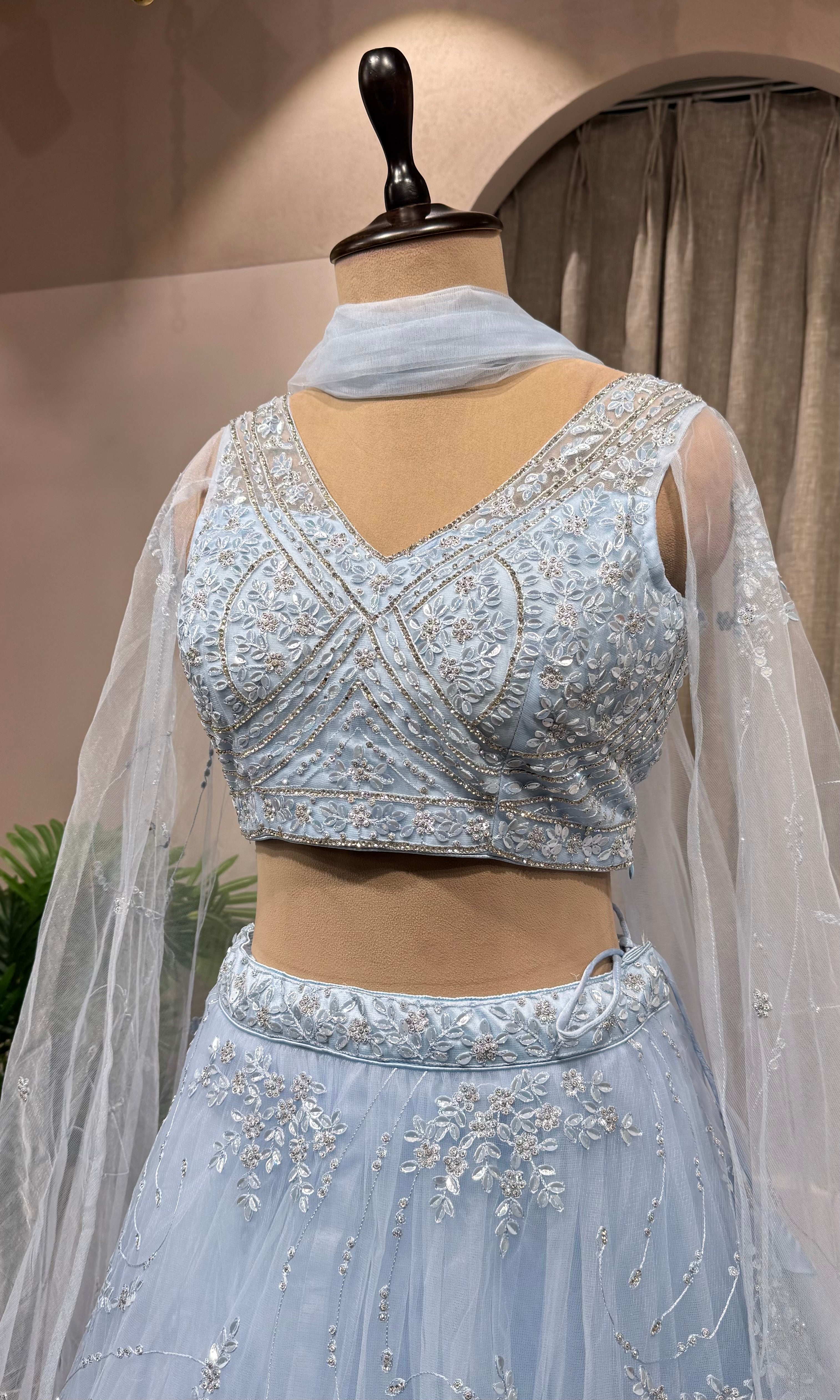 blue floral embroidered netted crop top lehenga