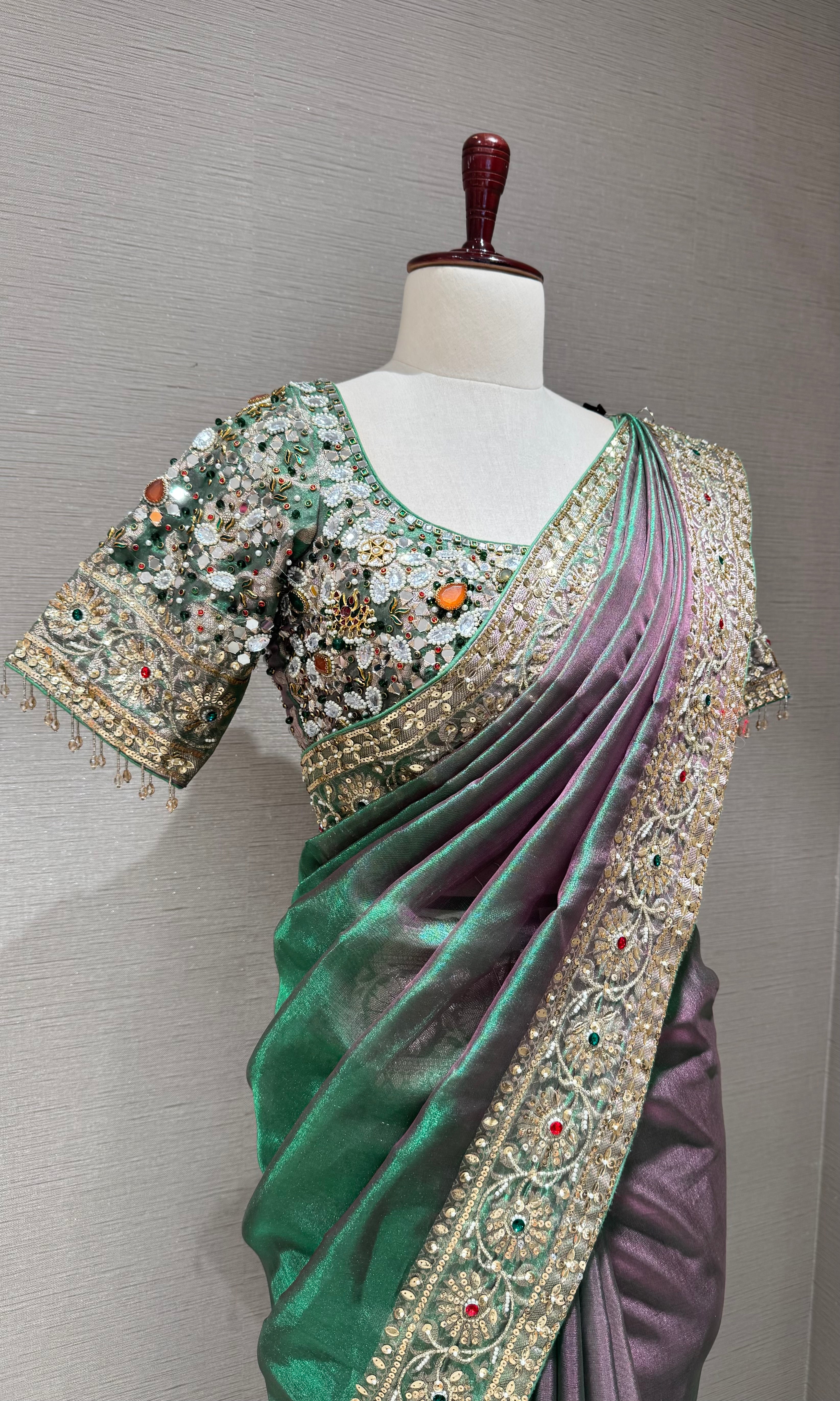 green silk blend saree with an embellished blouse