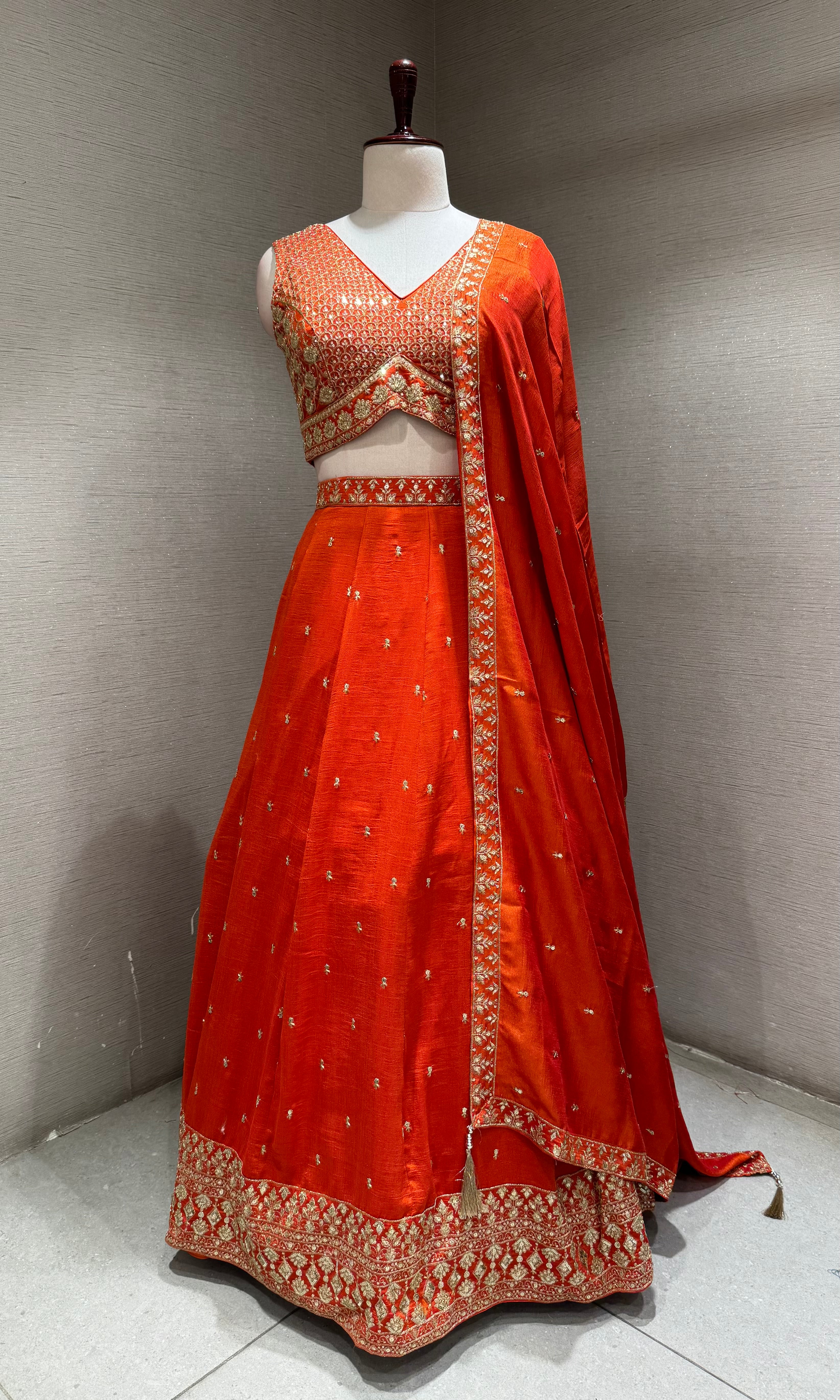 Orange Silk Lehenga Choli with Intricate Gold Borders