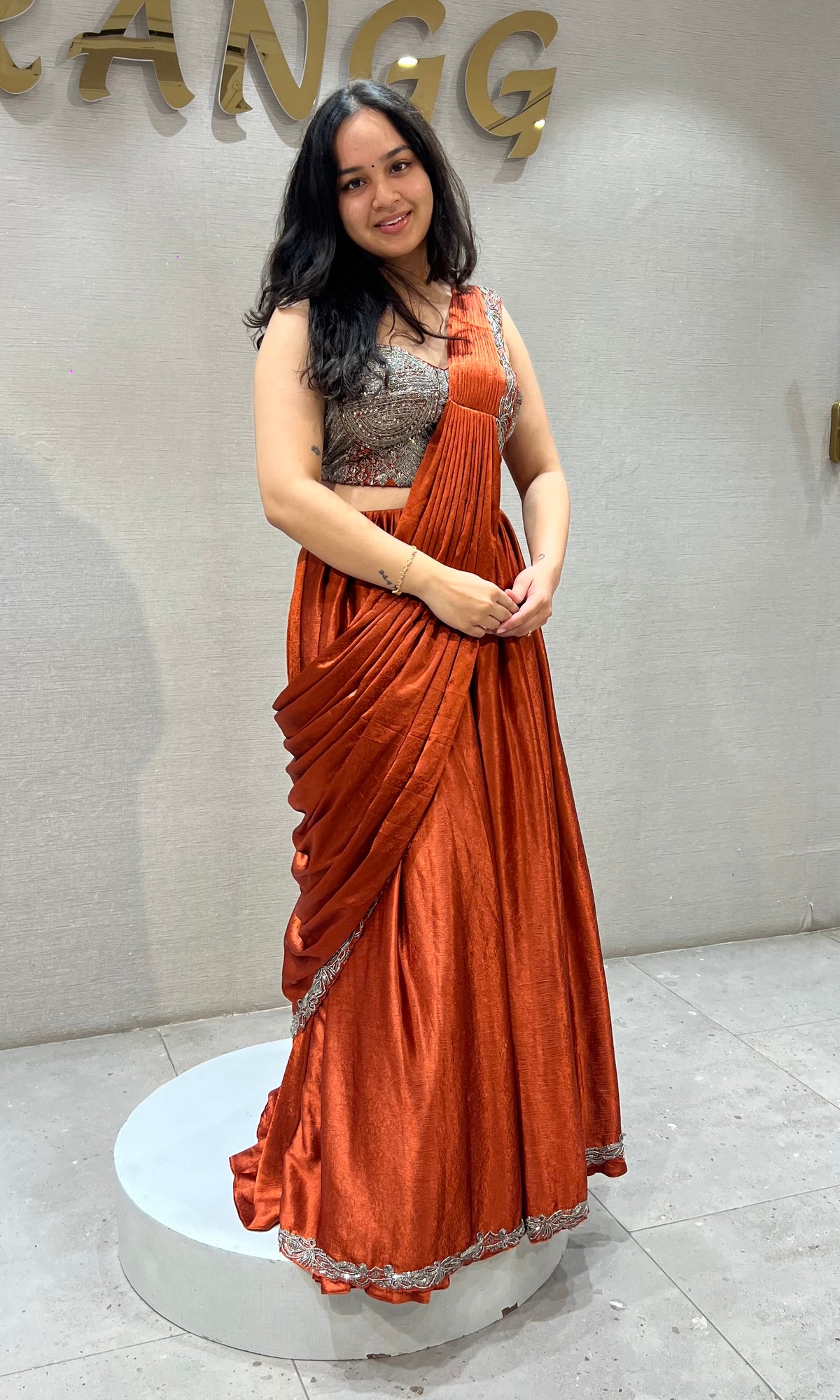 Rust Orange satin Draped lehenga with Silver embroidered Blouse