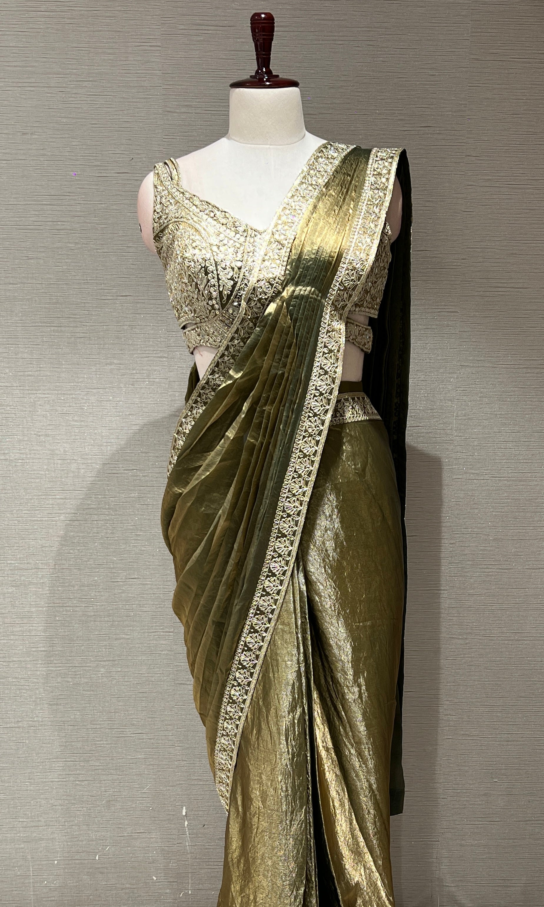 metallic green drape saree with gold border