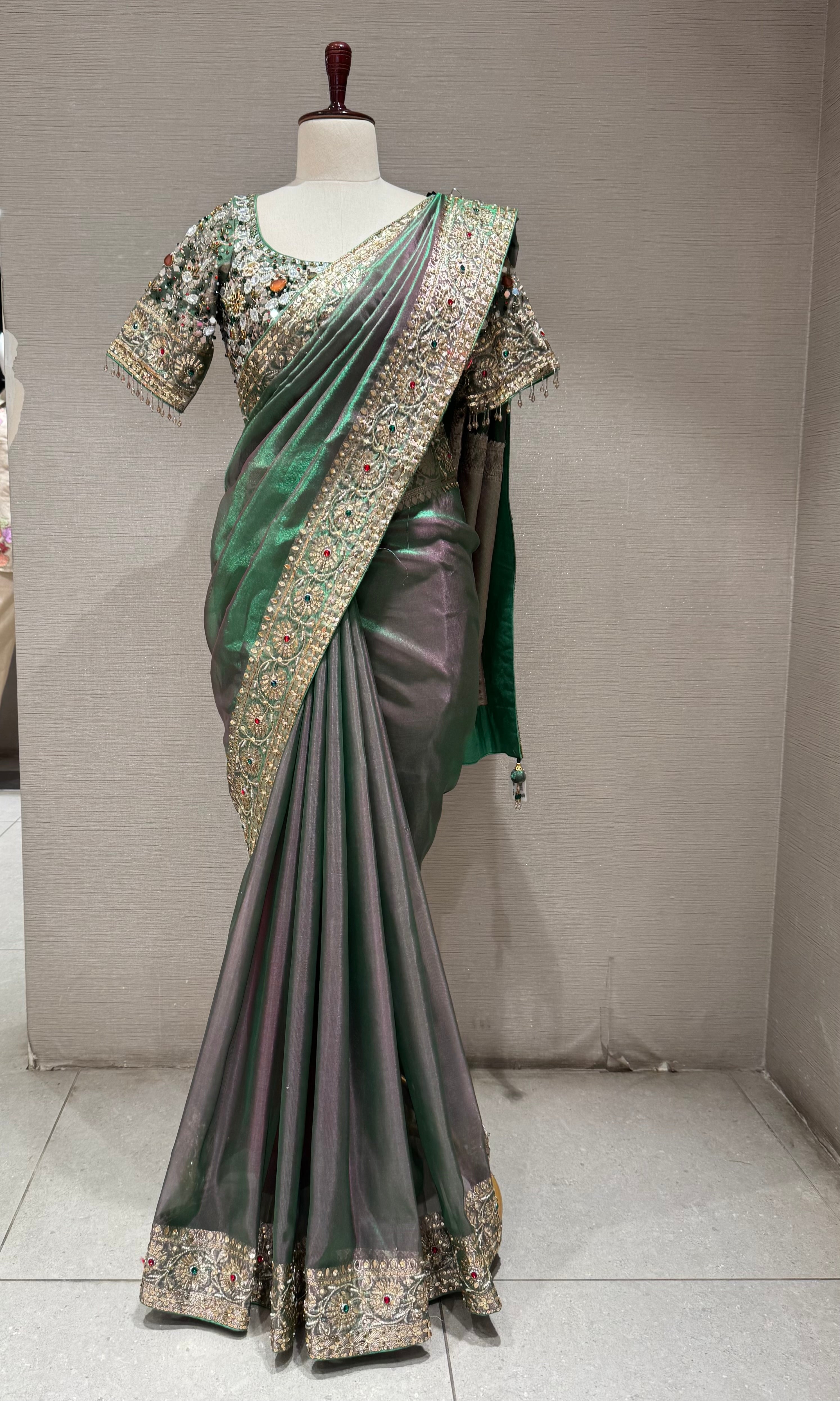 green silk blend saree with an embellished blouse