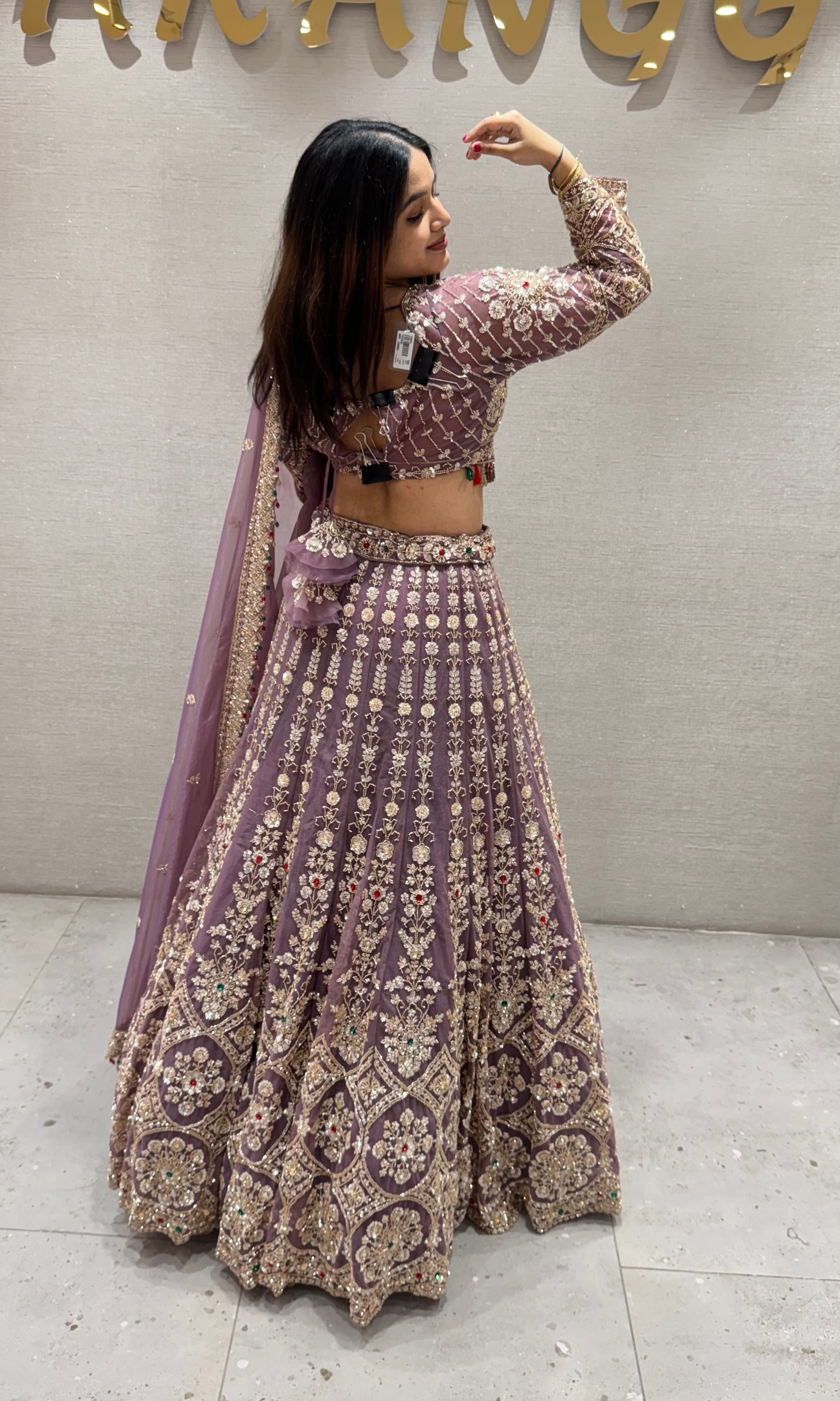 Purple lehenga with green and red contrast jewellery