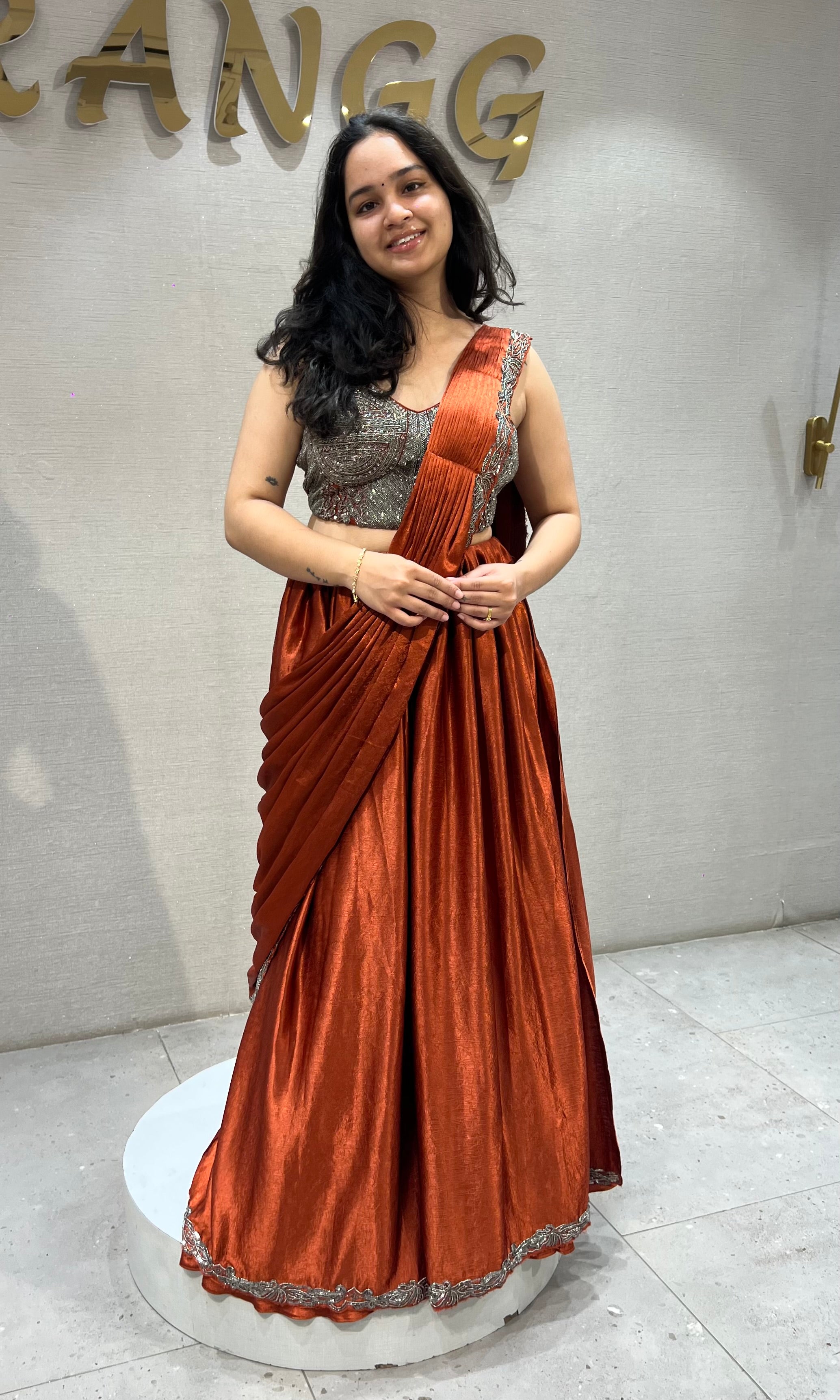 Rust Orange satin Draped lehenga with Silver embroidered Blouse