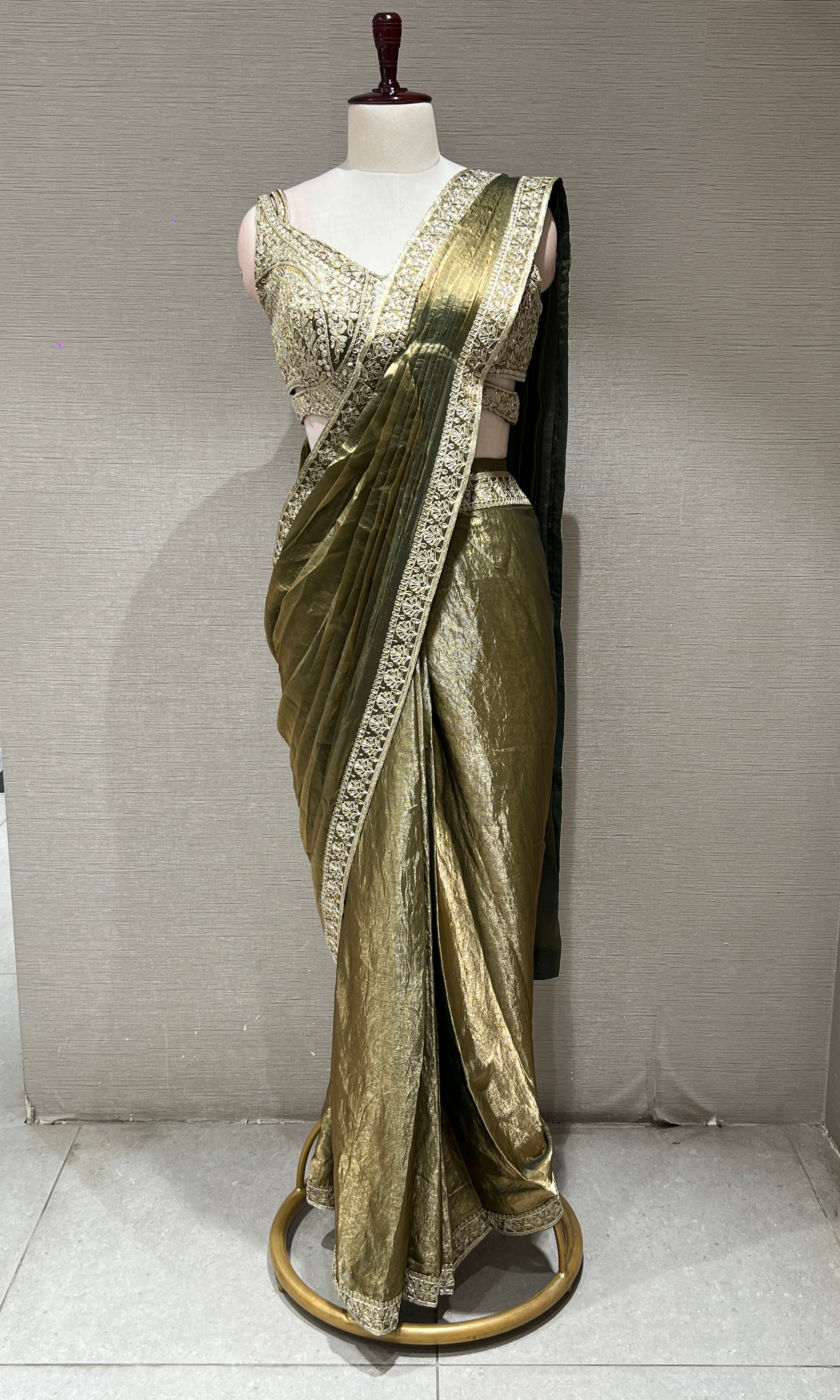 metallic green drape saree with gold border