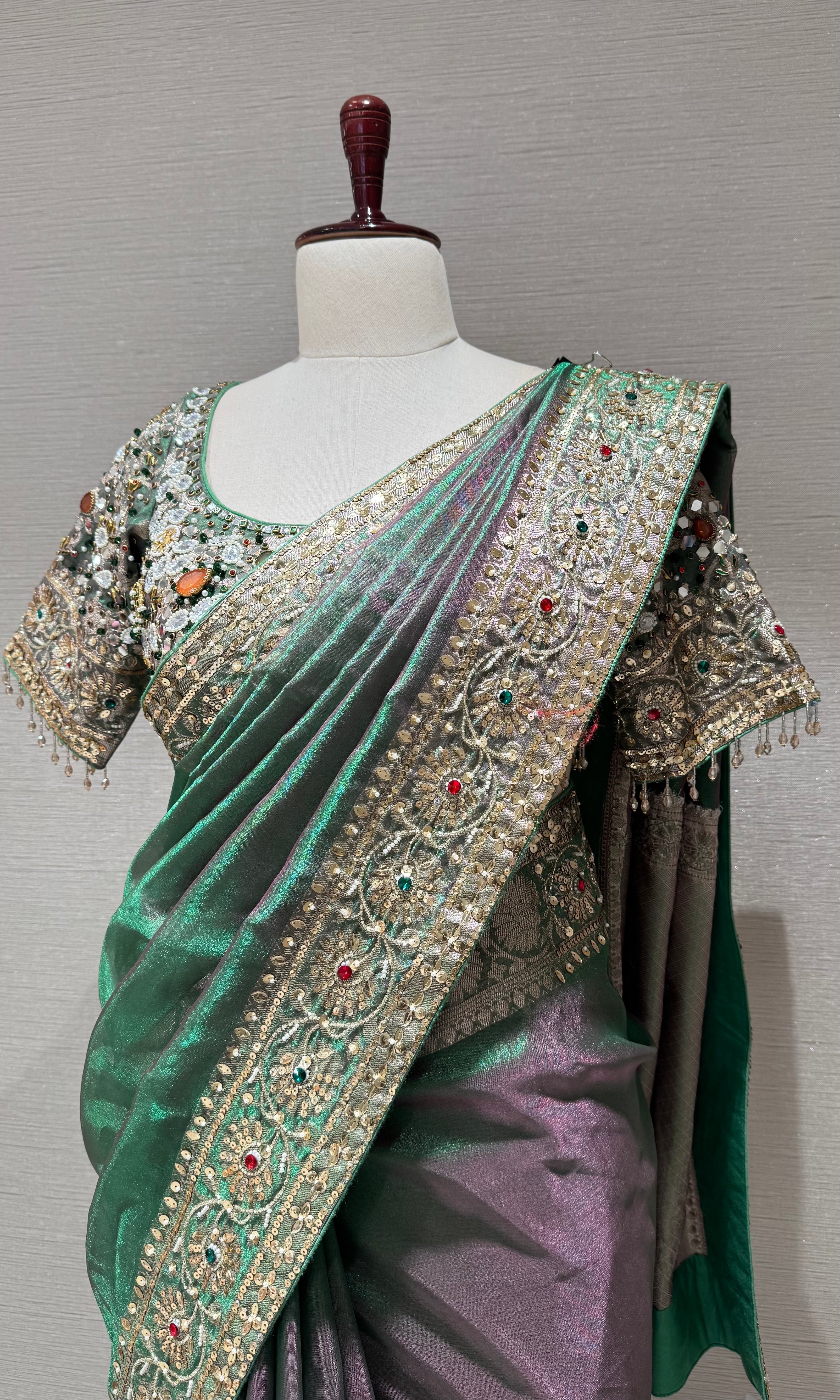 green silk blend saree with an embellished blouse